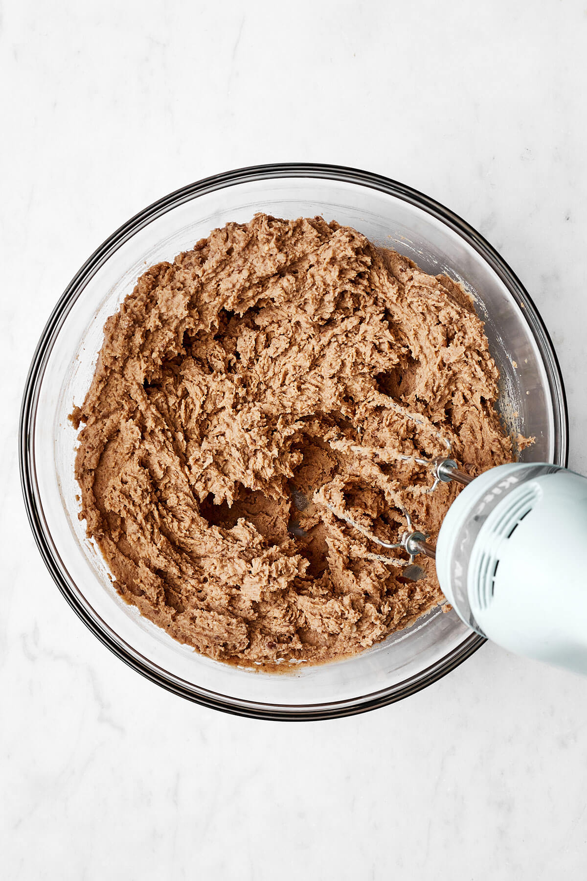 Mixing refried beans in a bowl for 7 layer dip