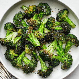 A white plate of air fryer broccoli