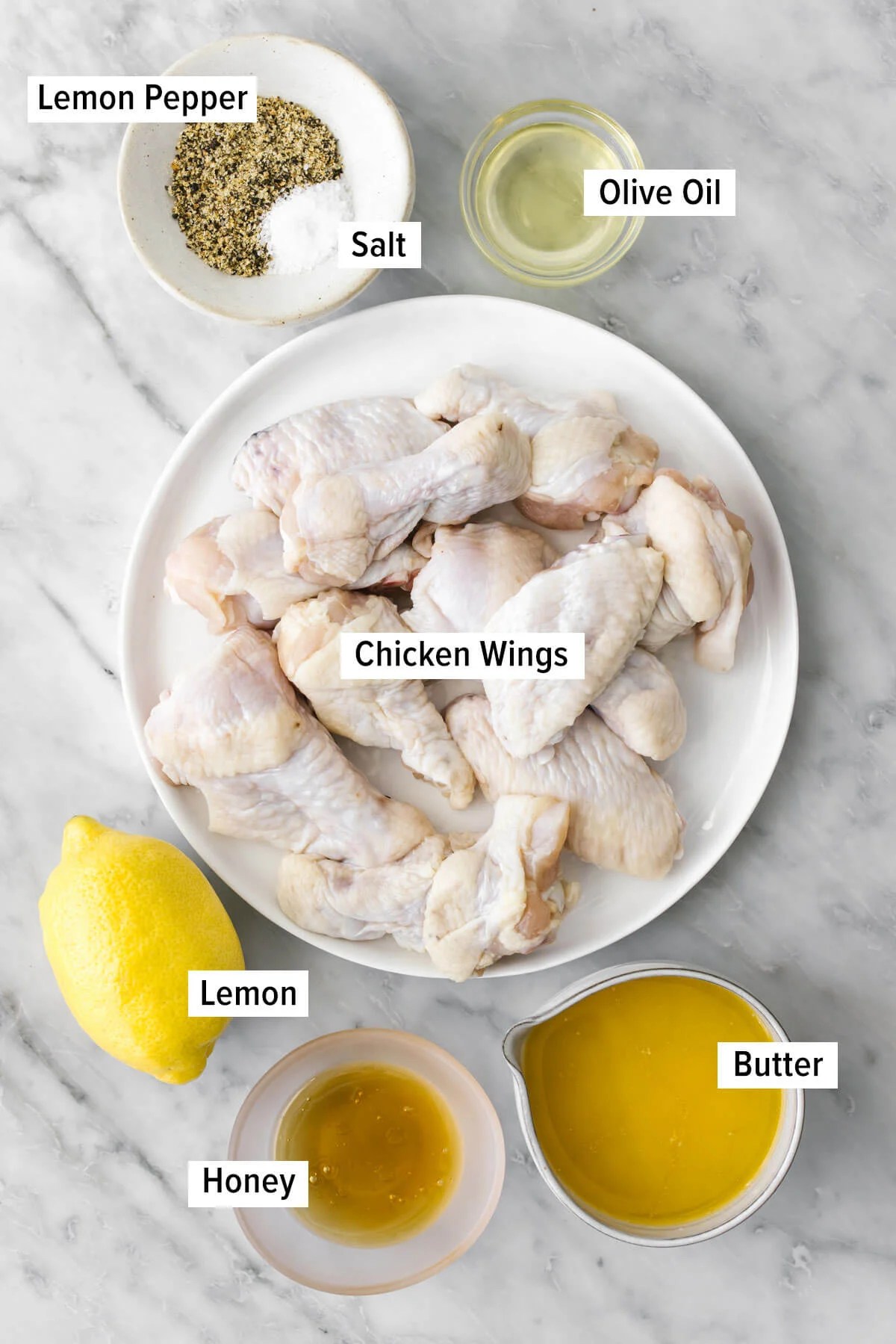 Ingredients for lemon pepper air fryer chicken wings on a plate