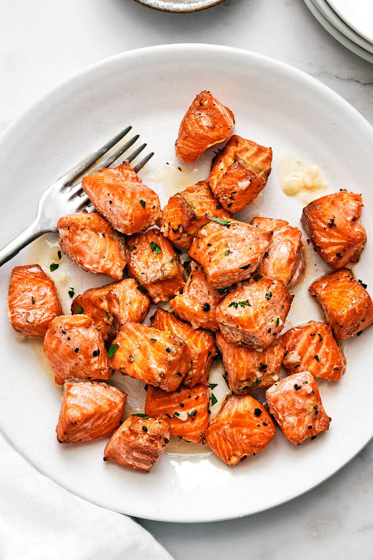 Air fryer salmon bites on a plate with a fork