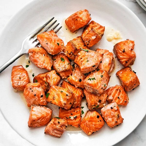 A white plate of air fryer salmon bites