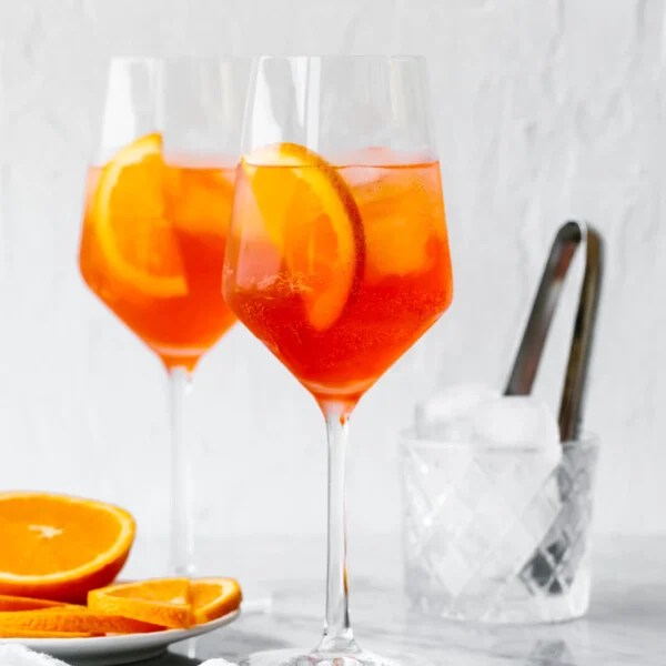 Aperol Spritz in glasses next to oranges