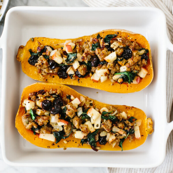 Two butternut squash halves stuffed with sausage apple filling.