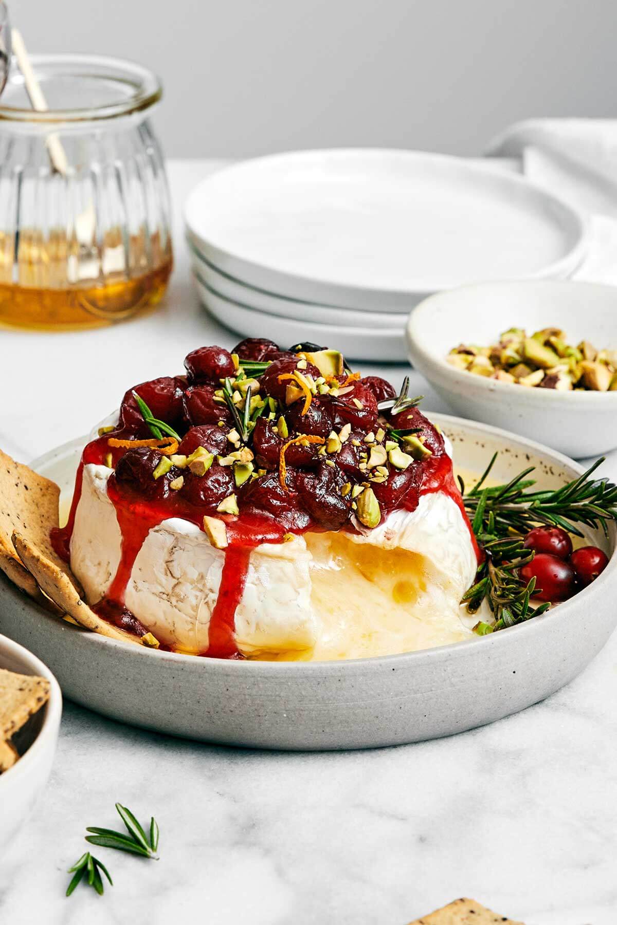 Baked brie with cranberry sauce on a plate. 