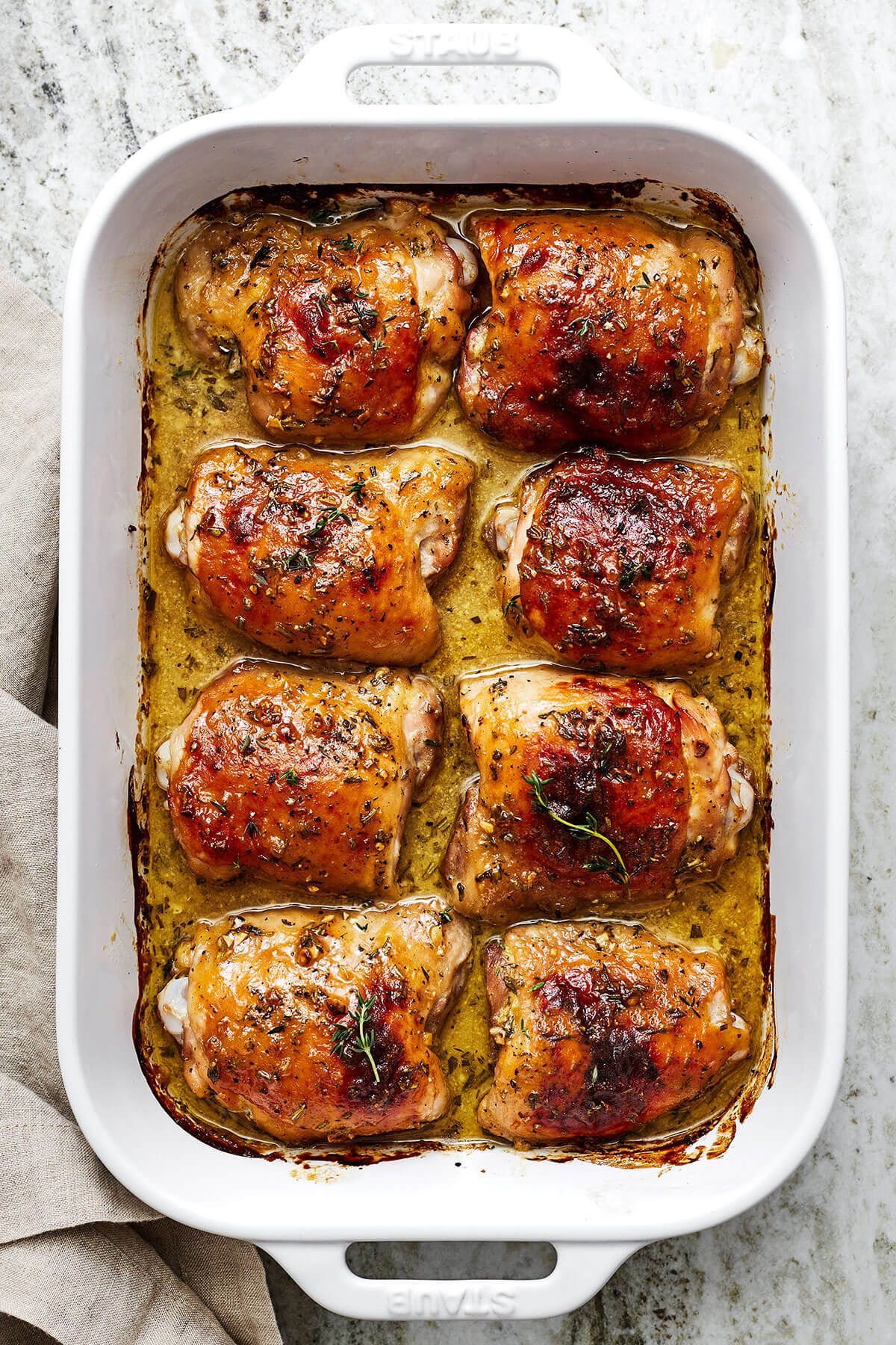 A casserole dish filled with honey mustard chicken thighs