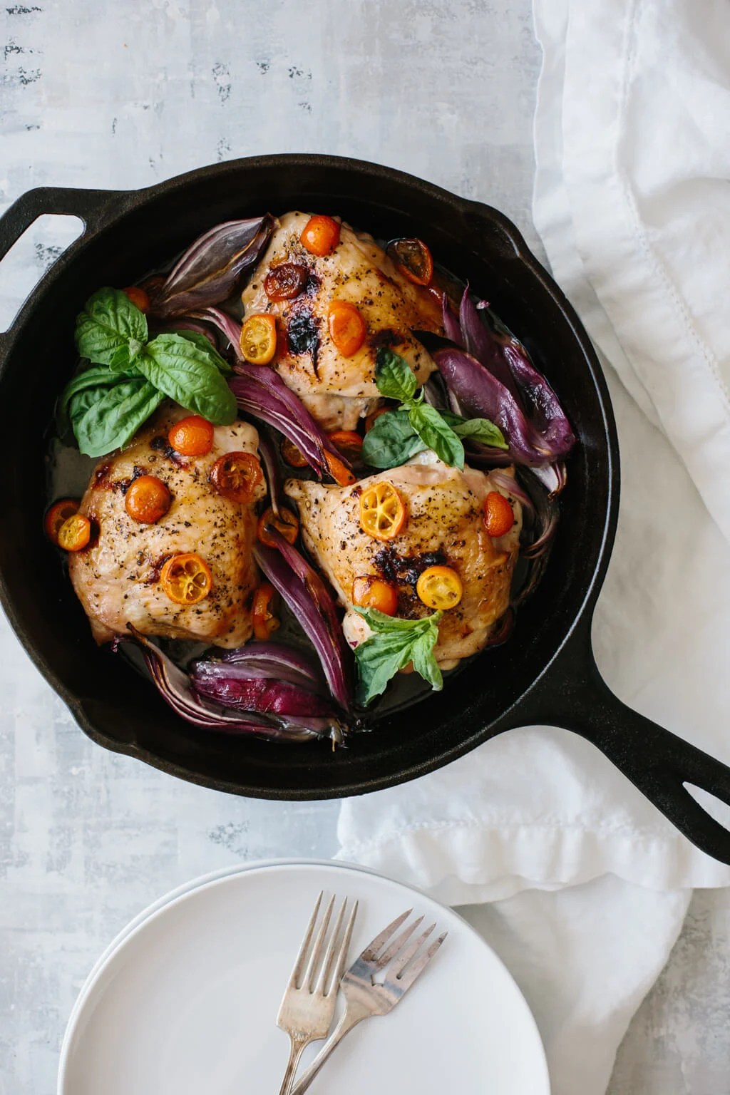 This one pan, roasted basil chicken is an easy meal that's bursting with flavor. Red onions and sliced kumquats become deliciously sweet when roasted.