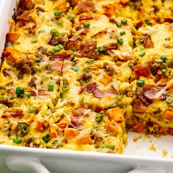 An easy breakfast casserole with sausage in a white pan next to forks.