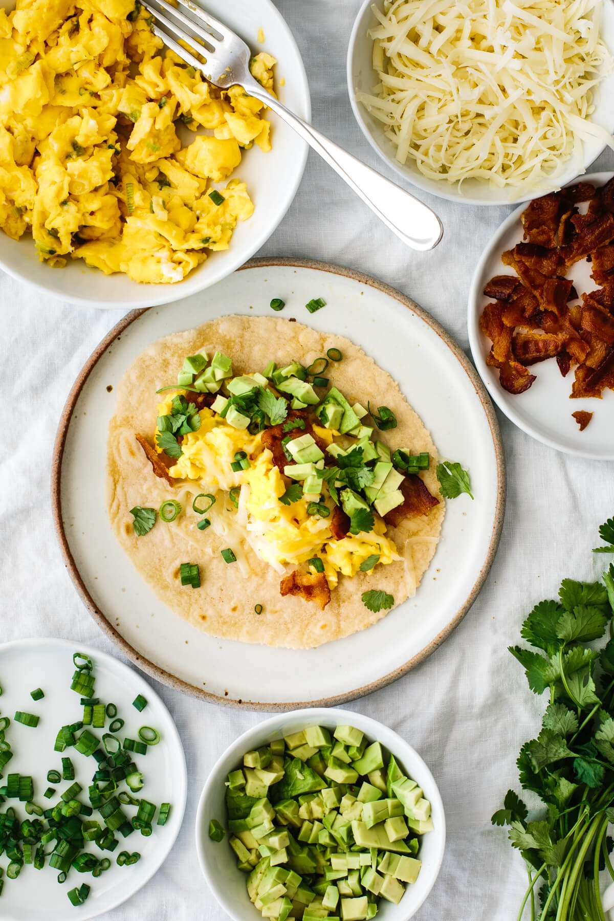 Breakfast taco assembly on a table.