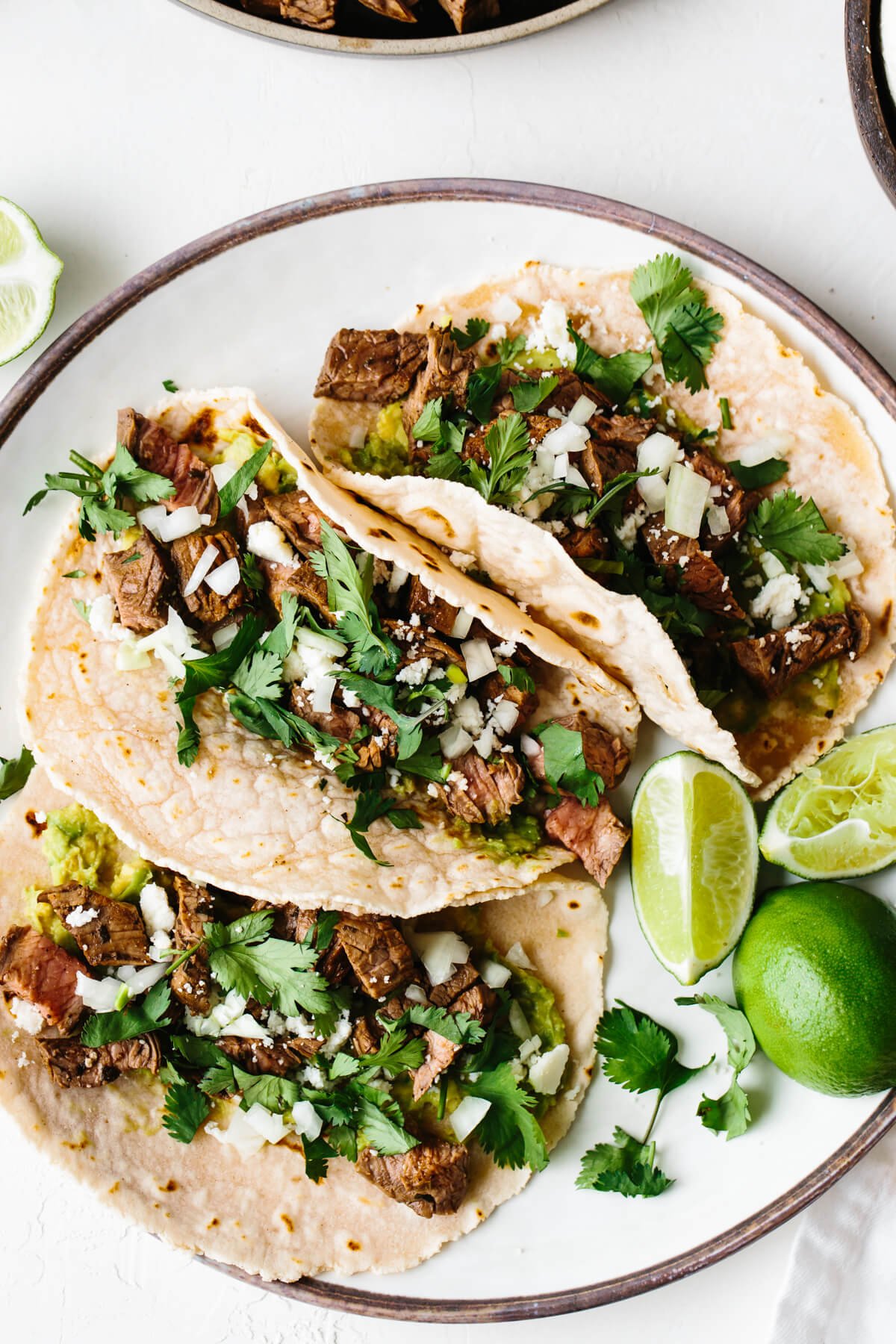 Carne asada tacos on a plate.