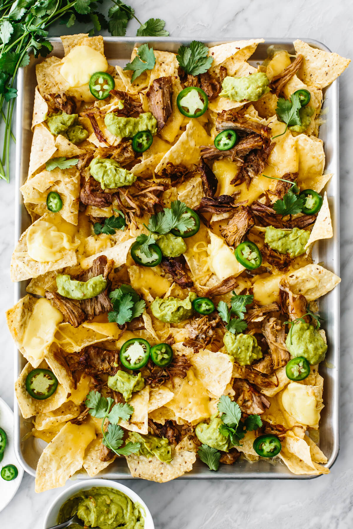 A tray of carnitas nachos on a table