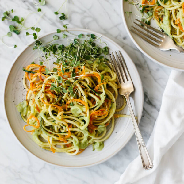 Carrot and zucchini pasta is mixed with a creamy, avocado cucumber sauce for a simple and delicious zucchini noodle recipe that's gluten-free, vegan, paleo and whole30.
