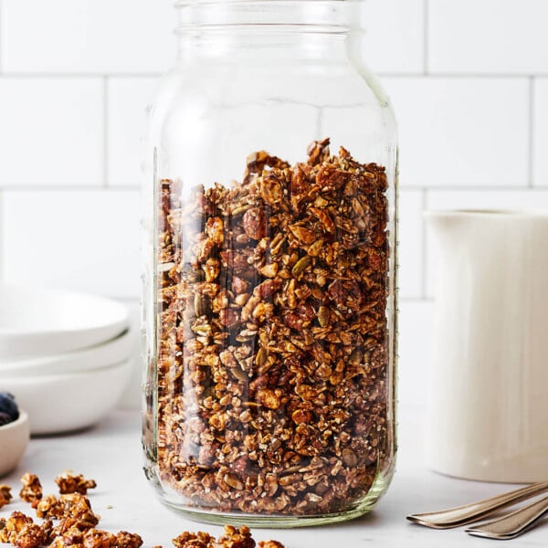 A large glass jar filled with chai spiced granola