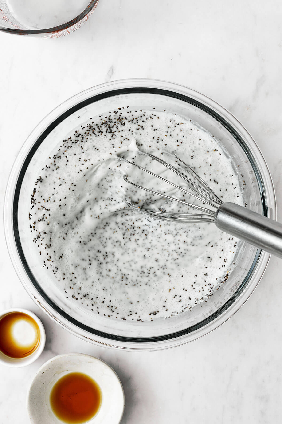 Whisking chia pudding in a large bowl