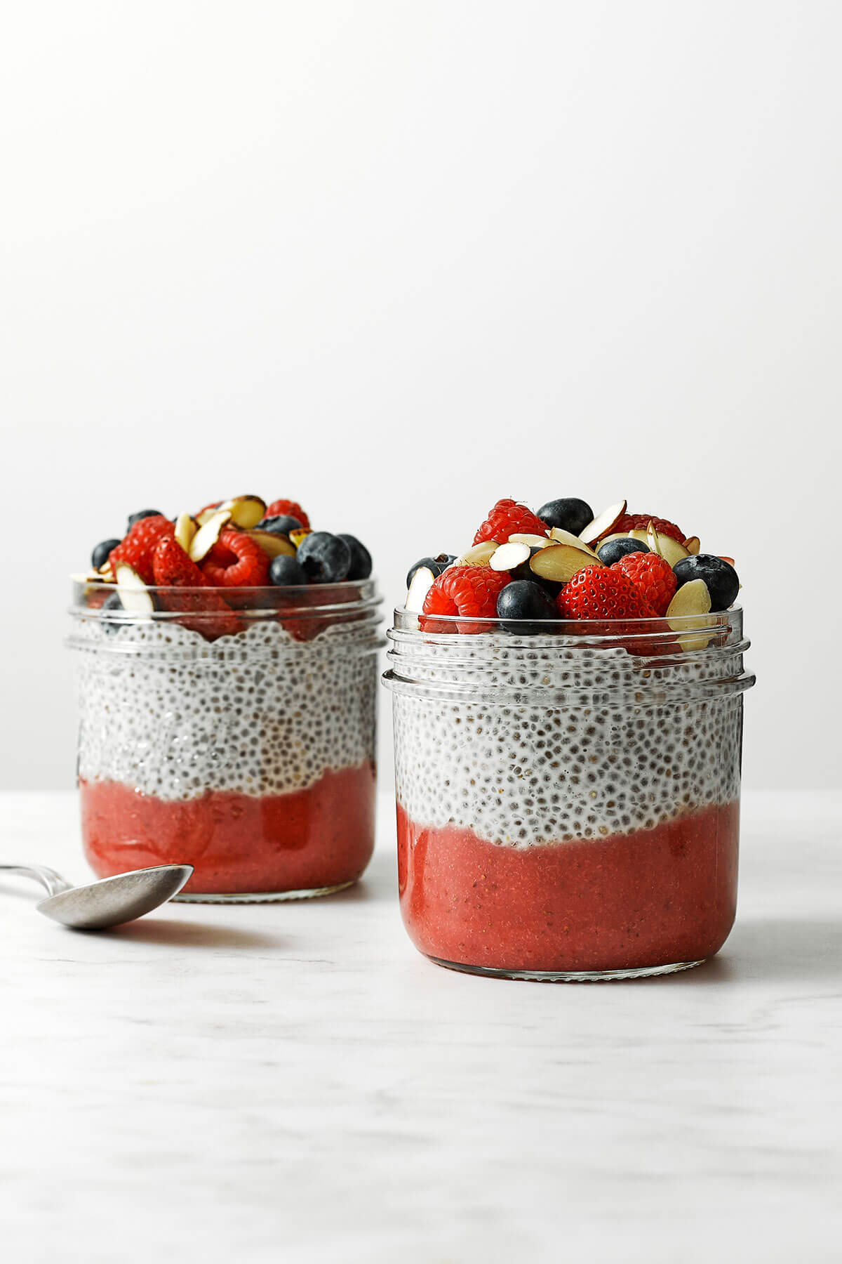 Two jars of chia pudding with fruit