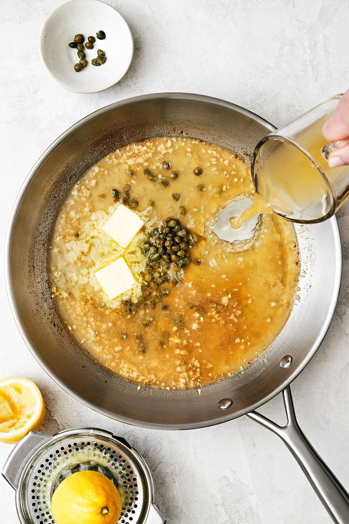 Making wine sauce in pan for chicken piccata
