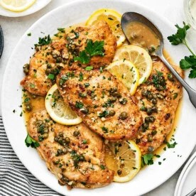 Chicken piccata filled on a white plate