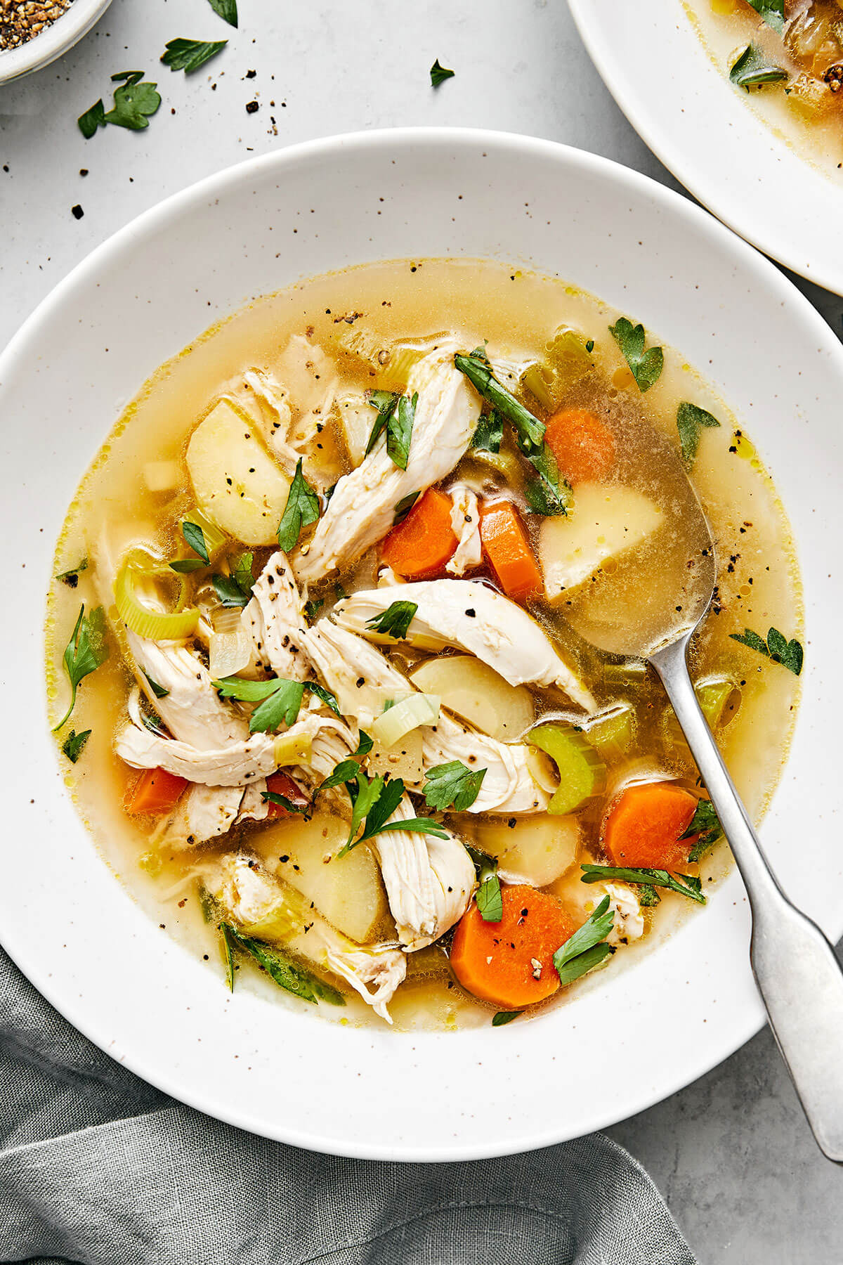 A white bowl of chicken soup