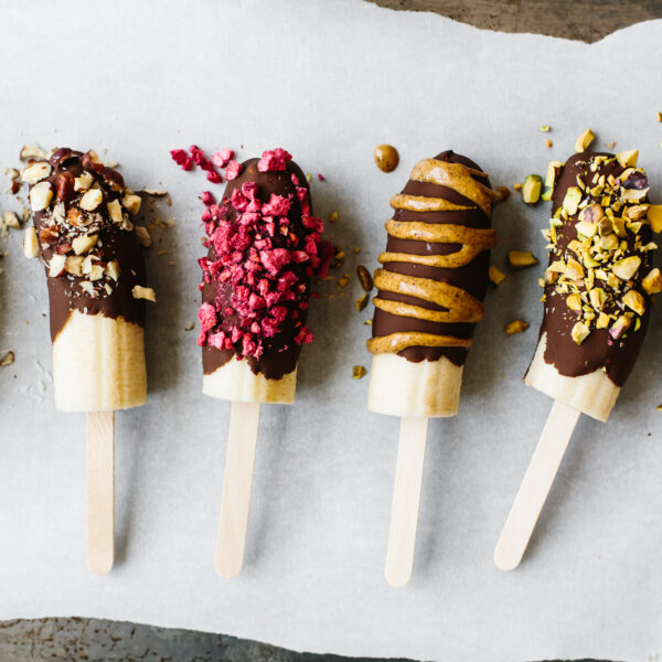 Chocolate covered bananas with different toppings