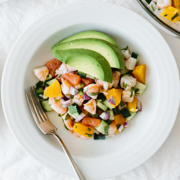 Shrimp Ceviche in a white bowl topped with avocado.