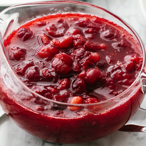 A bowl of cranberry sauce on a table.