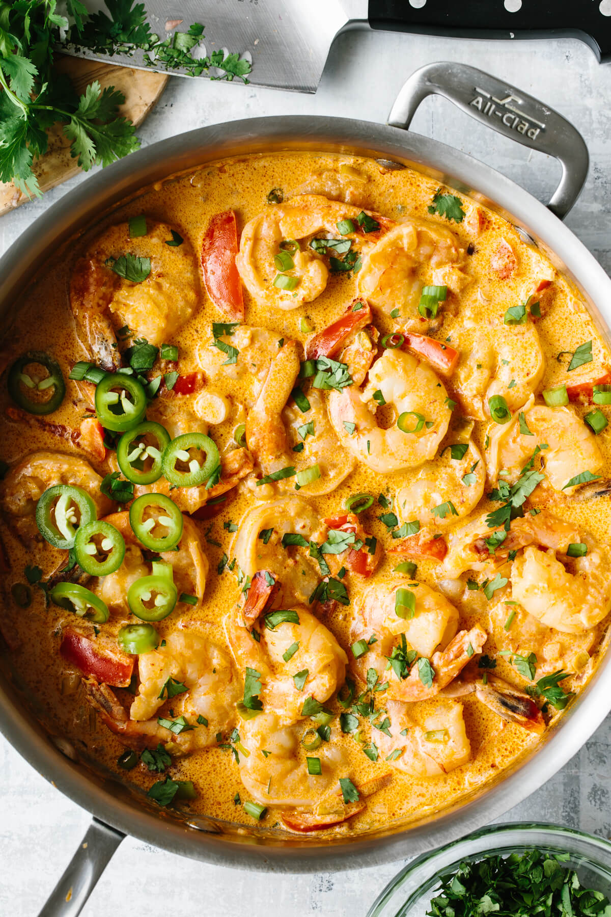 Creamy chipotle shrimp in a saute pan with garnish.