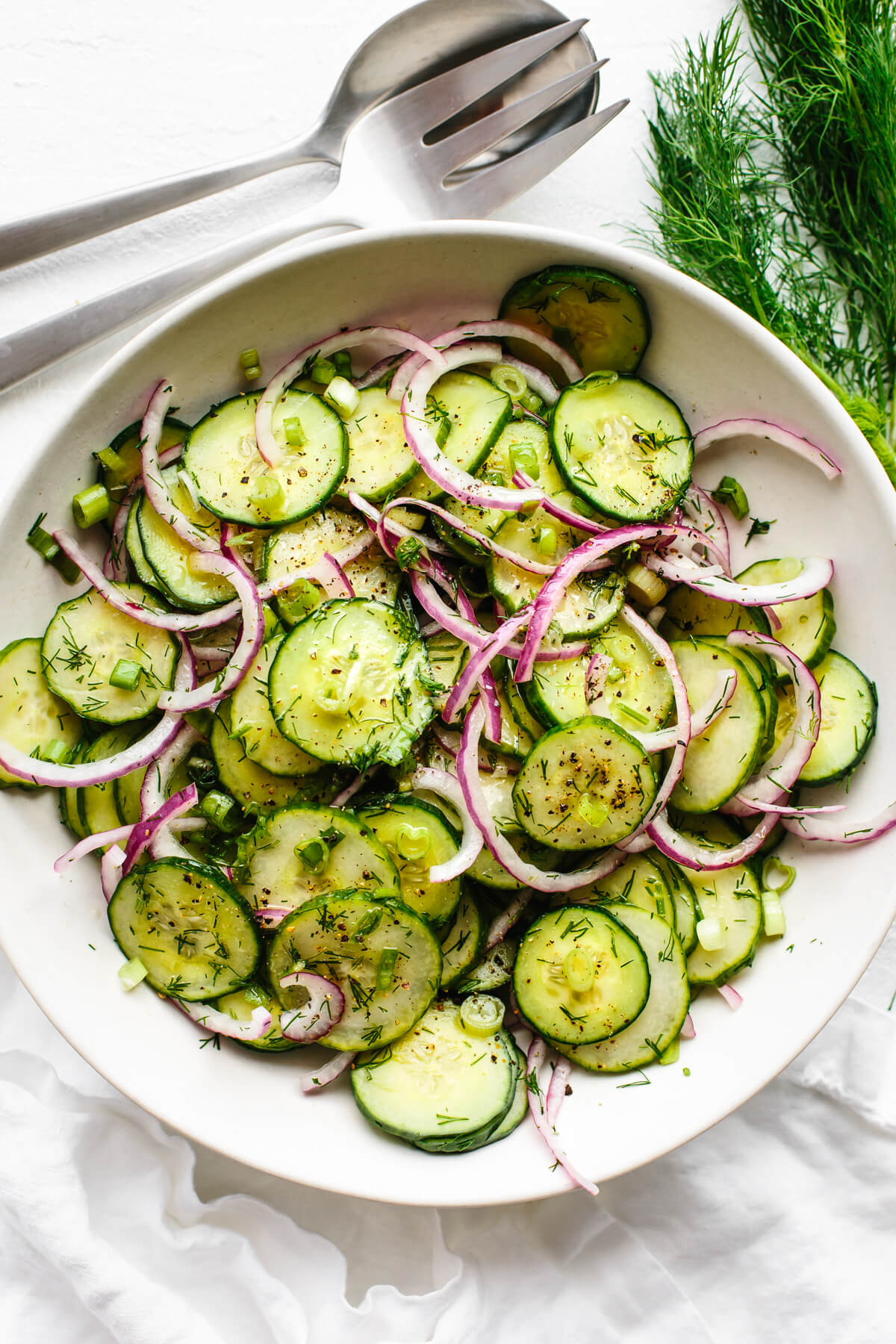 Cucumber salad in a large white bowl