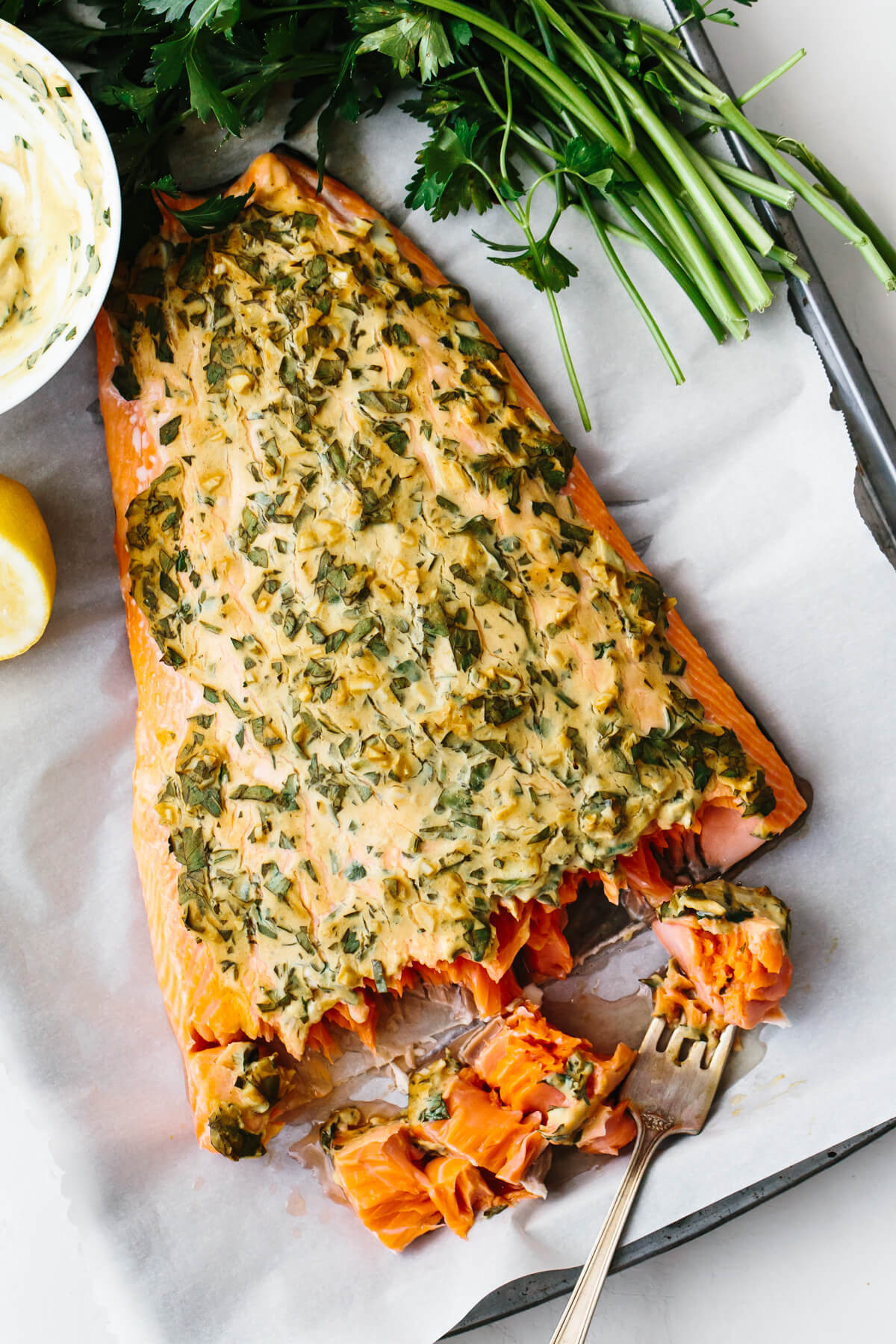 Dijon baked salmon on a tray with a fork.