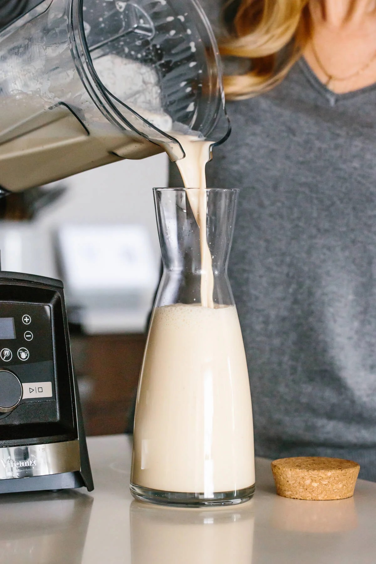 Pouring eggnog into a glass container.