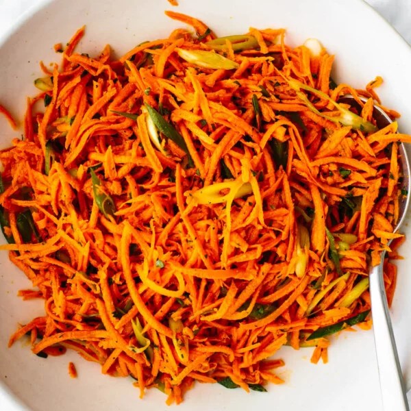 A large bowl of French carrot salad with a spoon