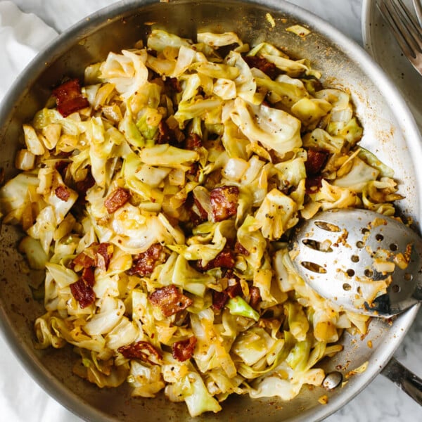 Fried cabbage in a stainless steel pan.