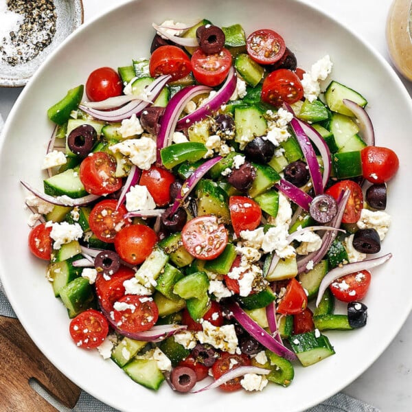 A white bowl of Greek salad