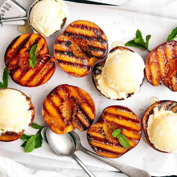 A tray of grilled peaches and ice cream