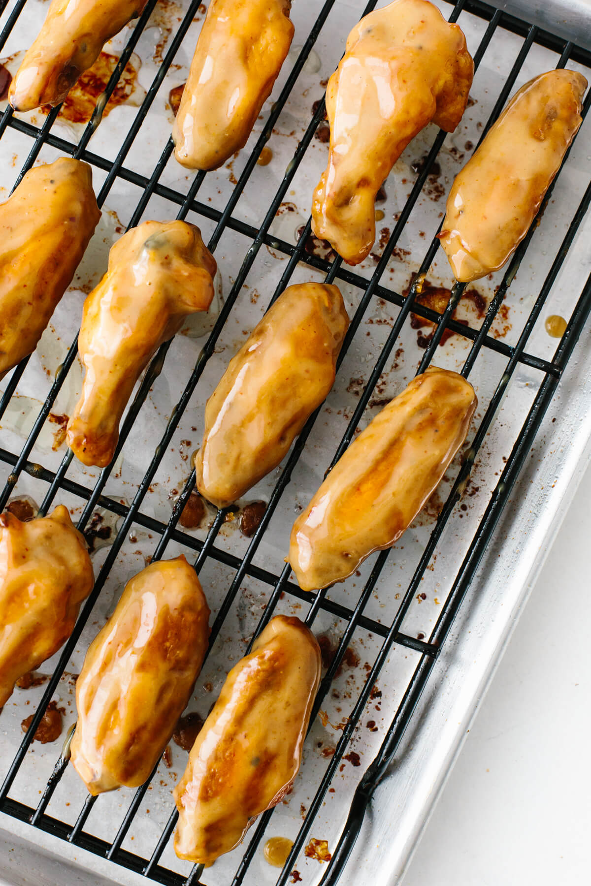 Honey mustard chicken wings on baking rack.