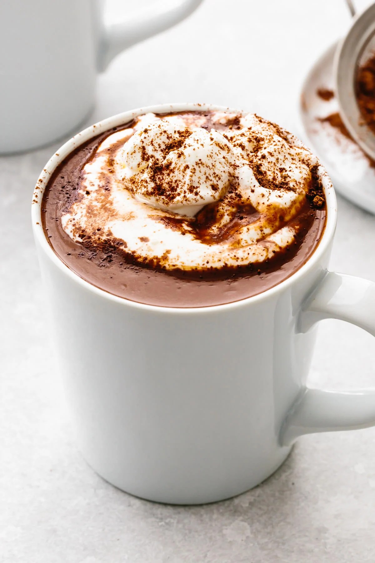 A white mug of hot chocolate and whipped cream.