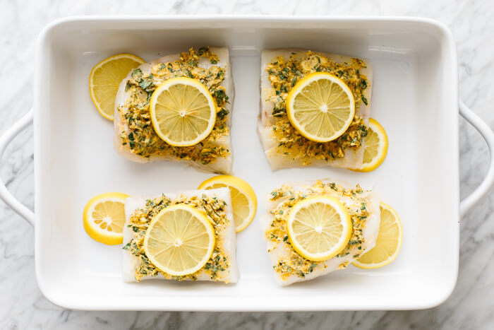 Cod fillets topped with lemon slices.