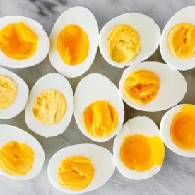 Hard boiled and soft boiled eggs on a counter