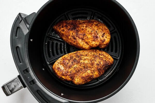 Seasoned chicken breasts in air fryer