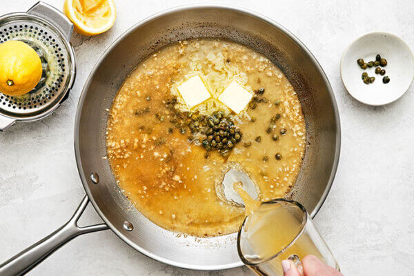 Making chicken piccata sauce in a pan