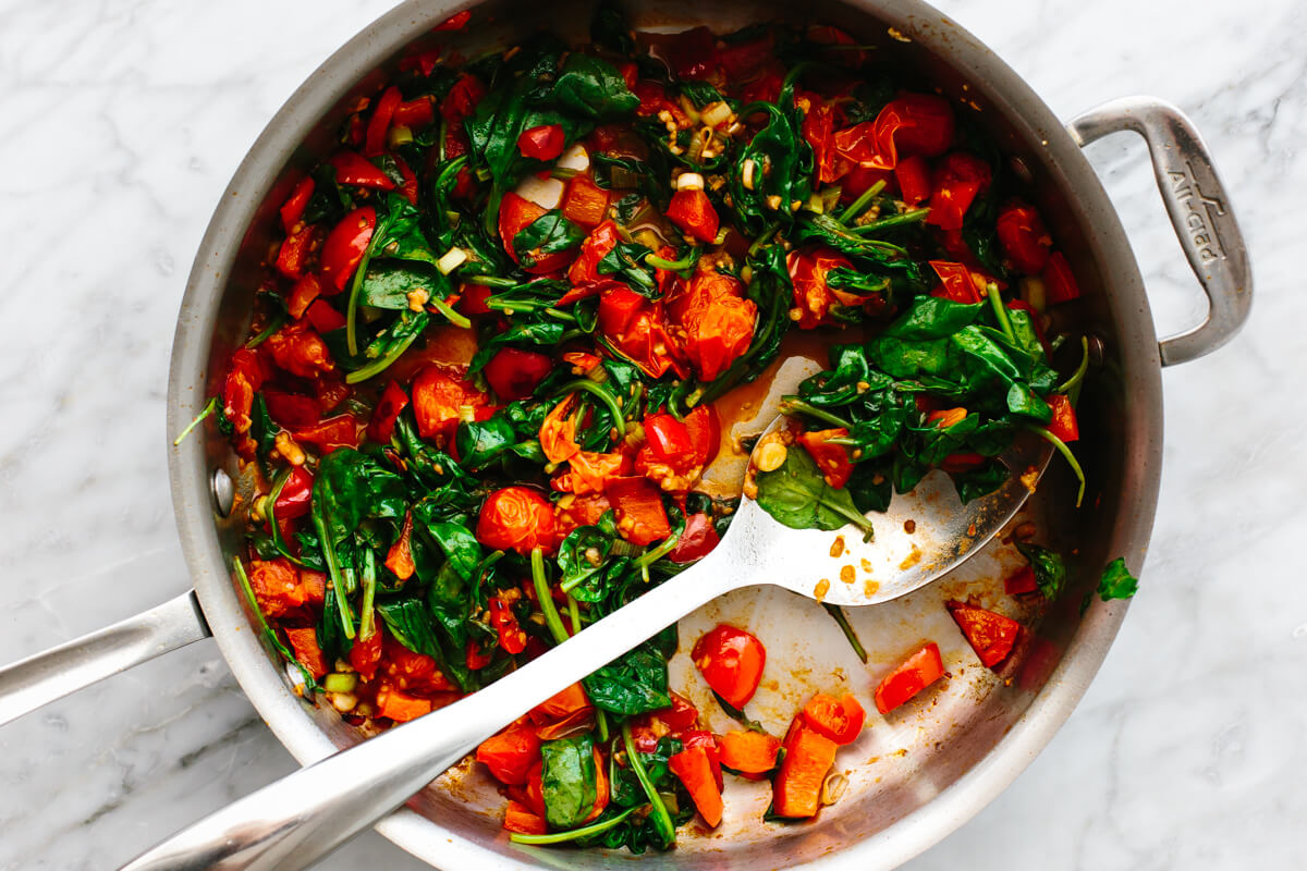 Sauteing tomatoes and spinach for Mediterranean ground beef stir fry