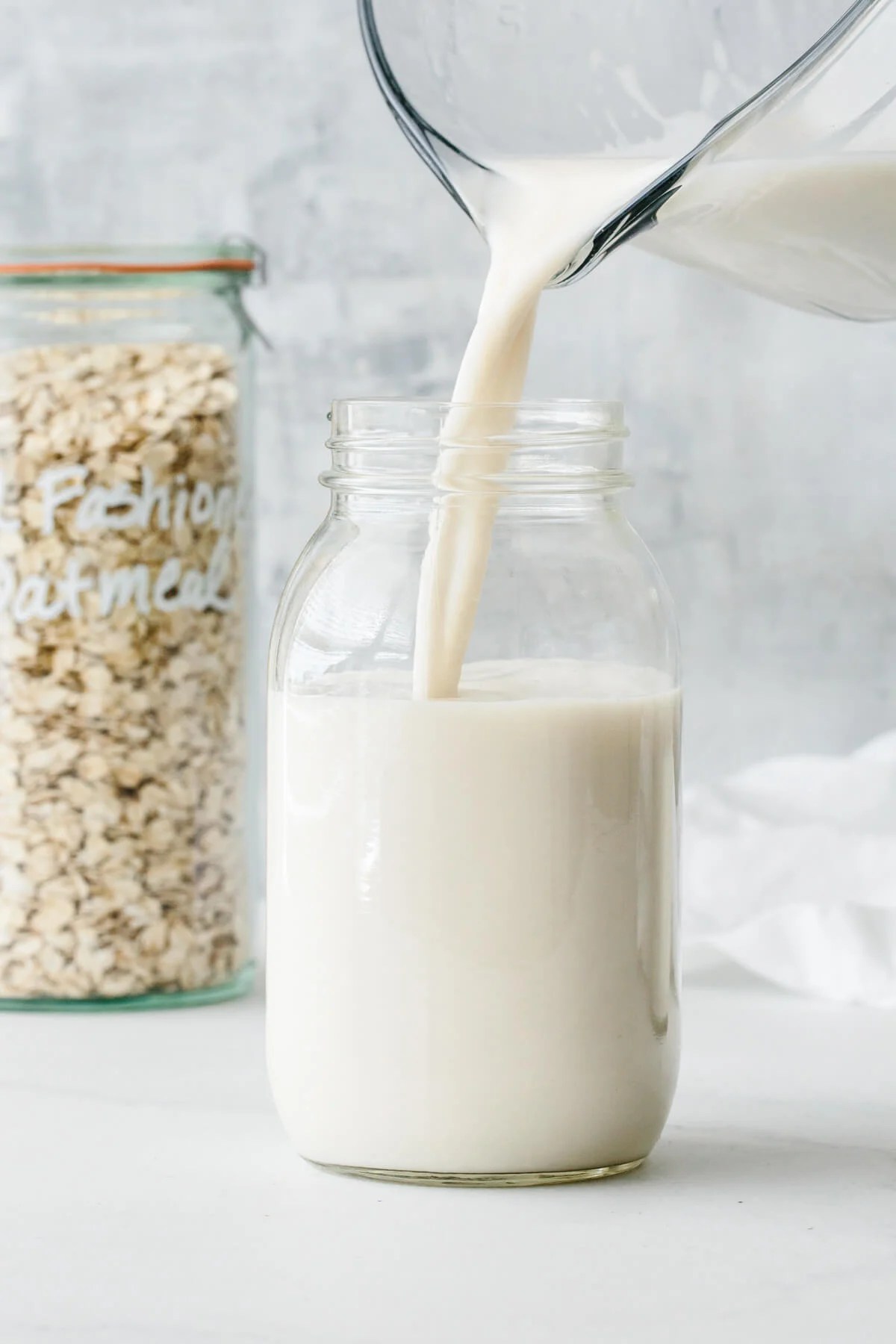 Oat milk poured into a glass container.
