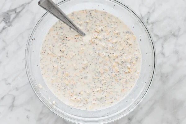 Overnight oats mixed in a large bowl with a spoon.