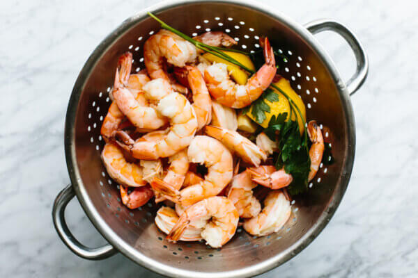 Chilled shrimp in a colander for shrimp cocktail