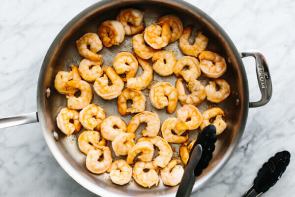 Cooking shrimp in a metal pan for shrimp fried rice