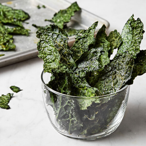 Kale chips in a glass mug.