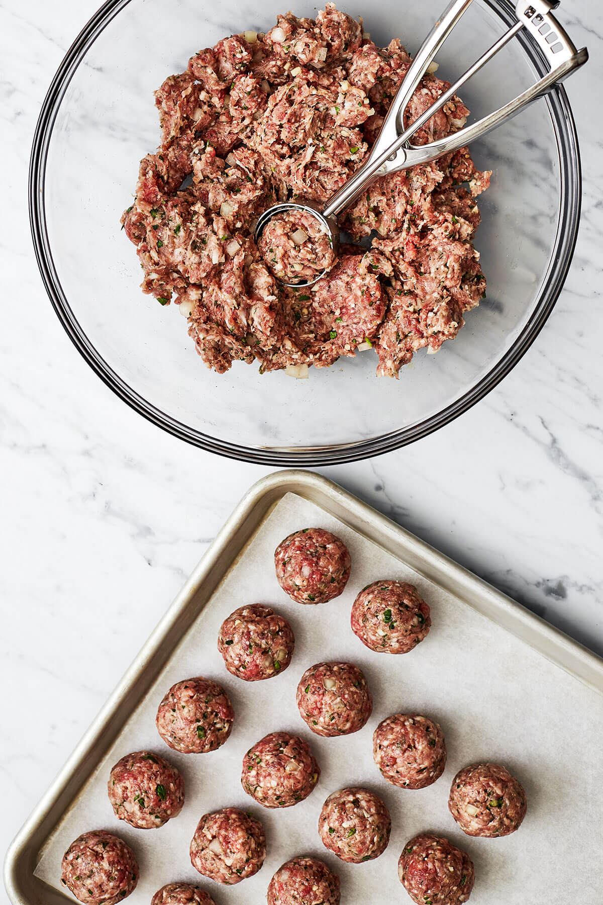 Forming meatballs and placing on a sheet pan