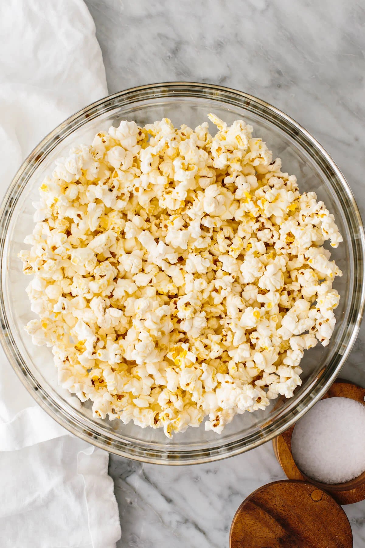 Microwave popcorn in a glass bowl on a table.