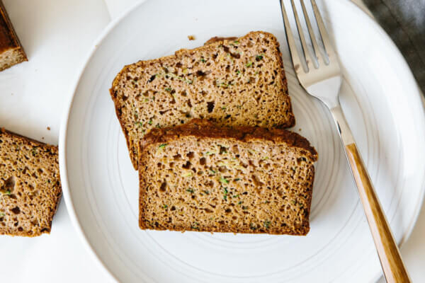 Two slices of paleo zucchini bread on a white plate.