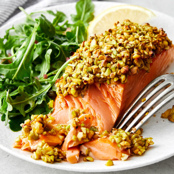 A plate of pistachio crusted salmon