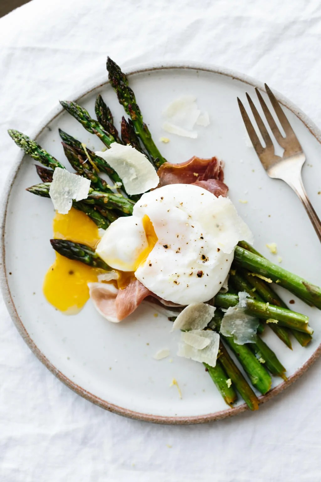 Breakfast doesn't get much better than garlic sautéed asparagus topped with prosciutto, a perfectly poached egg and a few shavings of parmesan.