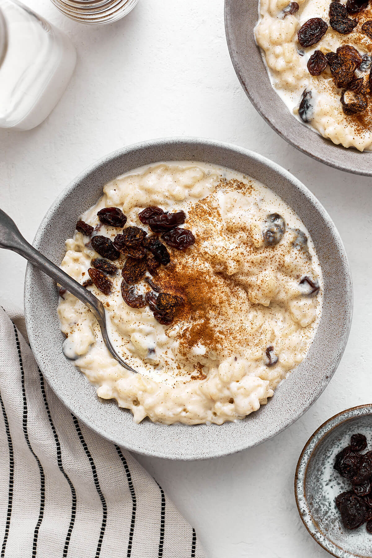A bowl of creamy rice pudding with cinnamon and raisins